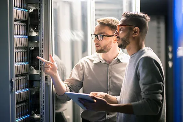 Engineers reviewing equipment in a data centre
