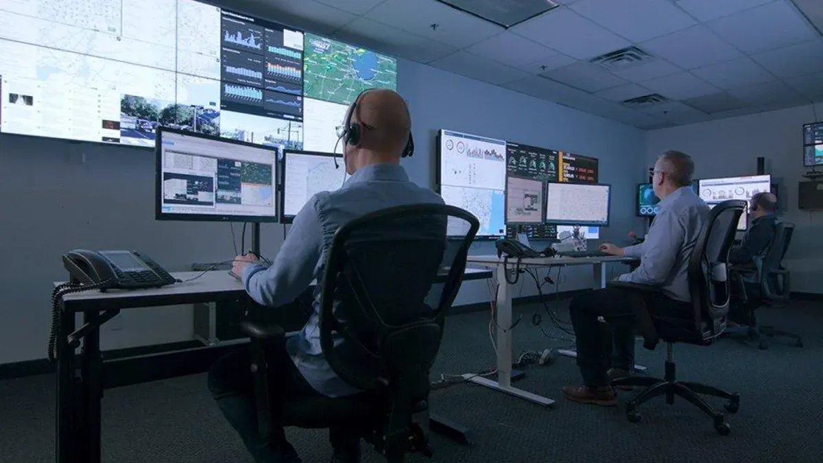 Two analysts at workstations in a security operations centre
